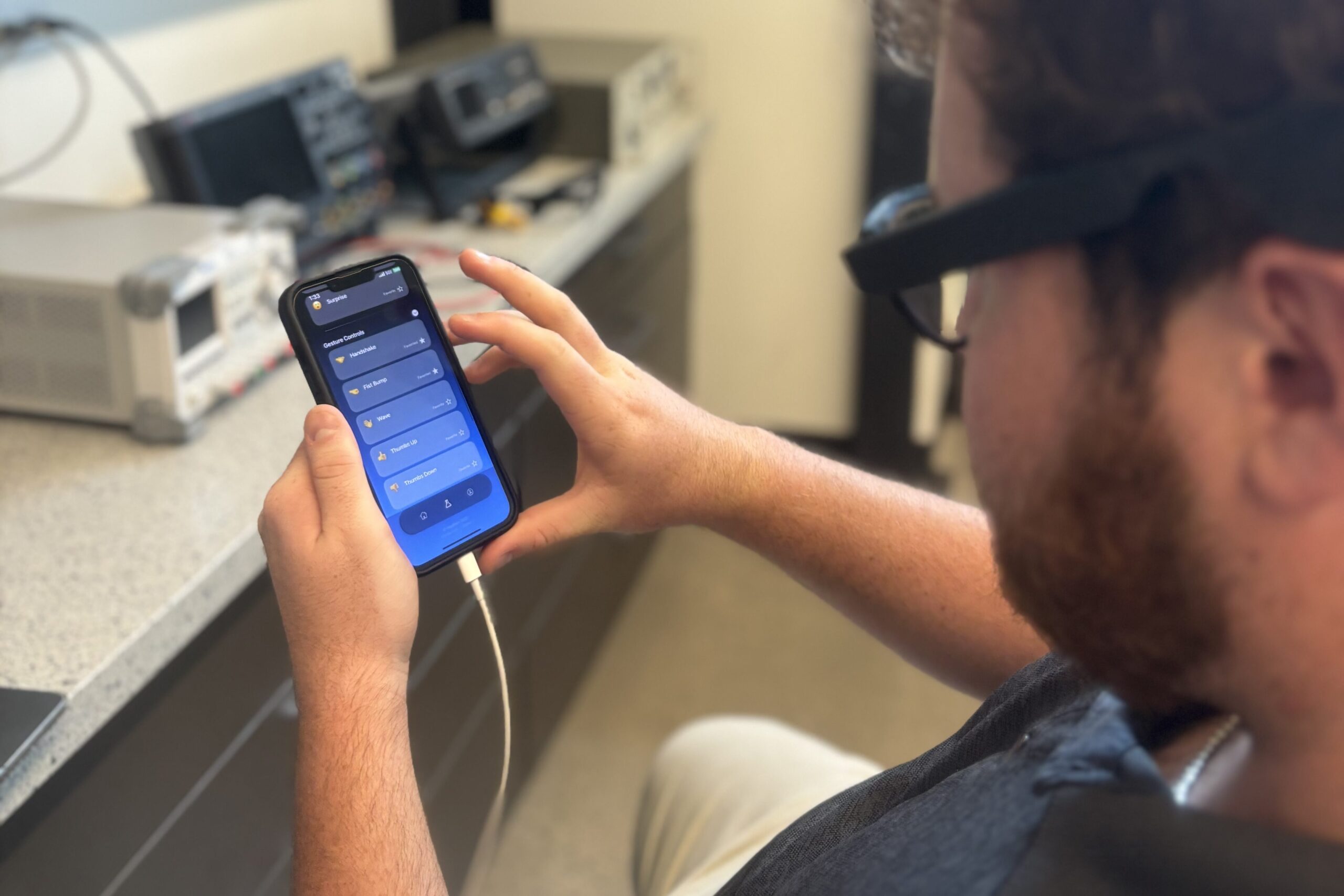 Man using the HapWare app to customize the vibration patterns he wants to feel.